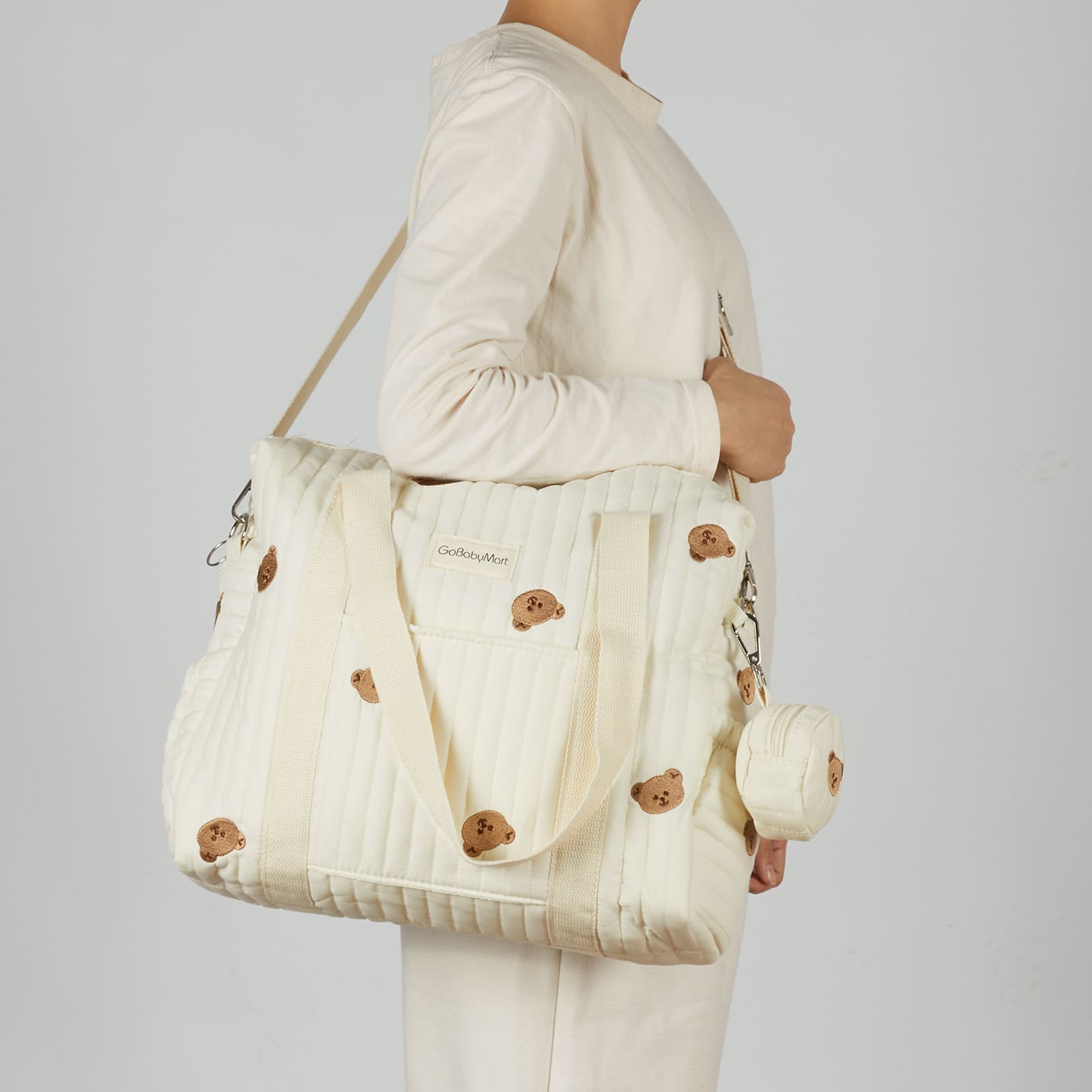 Model wearing a diaper bag crossbody #Color_Beige Bears