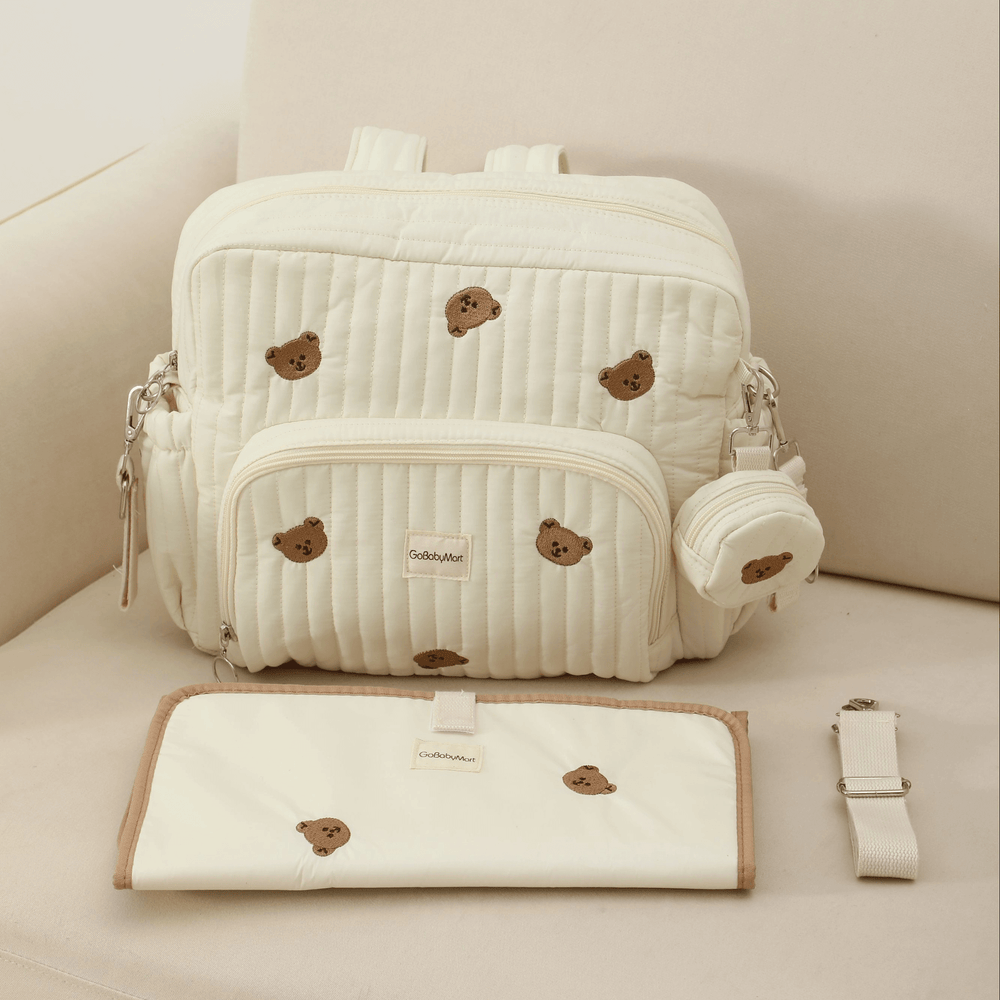 Diaper bag backpack Beige with changing pad and stroller straps on a sofa #Color_Beige - Bears