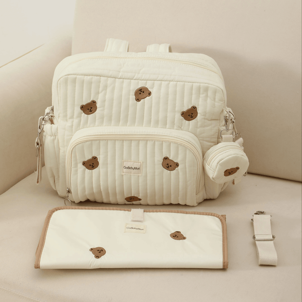Diaper bag backpack Beige with changing pad and stroller straps on a sofa #Color_Beige - Bears